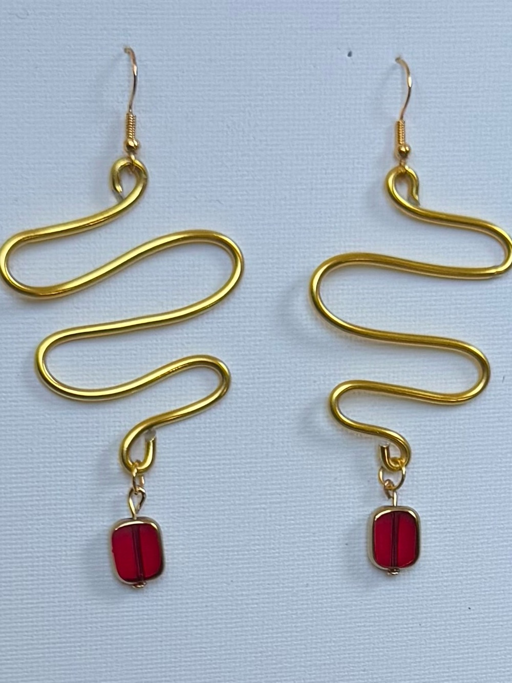 Handmade Gold wire Swirl Earrings with dangling Red Glass beads